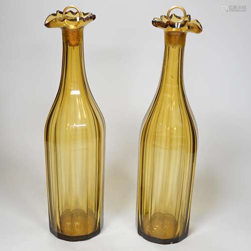 A pair of early 19th century amber panel cut glass decanters...