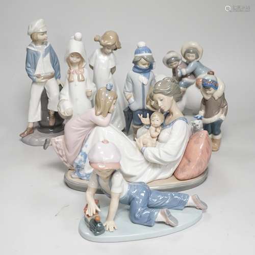 Seven Lladro figures; mother baby and child, boy with train,...