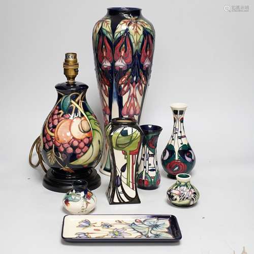 A group of Moorcroft vases, a lamp base and a pin dish, tall...