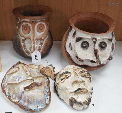 Two Papa New Guinea pottery face masks and two cooking pots,