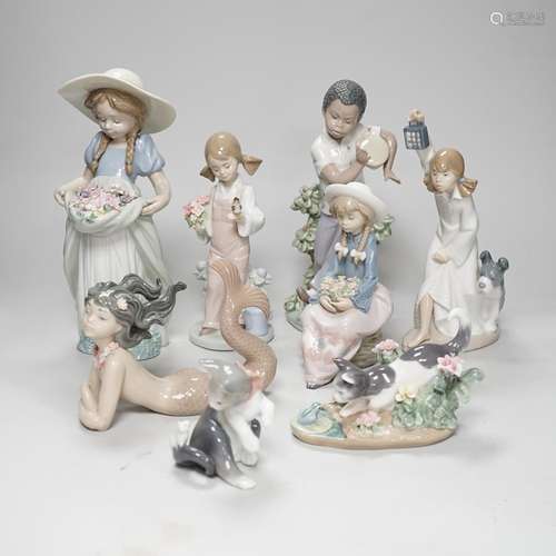 A large Lladro figure of a flower girl, mermaid, boy playing...