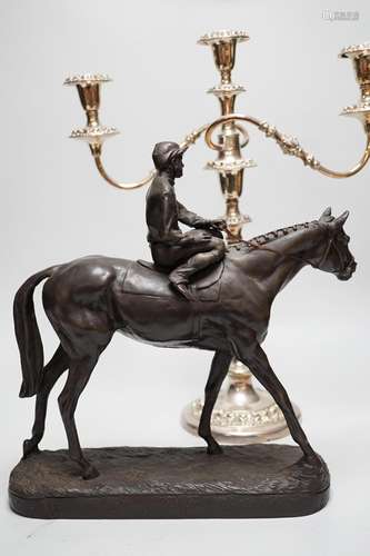 A bronzed resin racehorse and jockey group and a silver-plat...