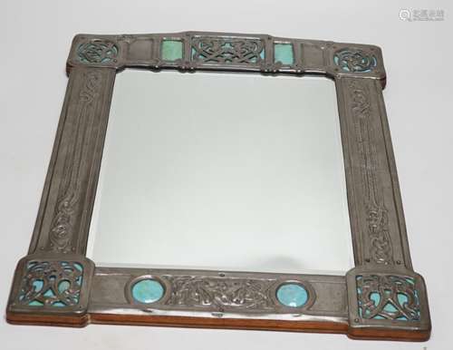 A Miller Brothers Art Nouveau embossed pewter mirror with ca...