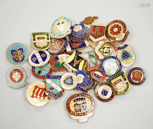 A collection of mixed badges, the majority enamelled