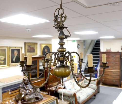 A Dutch style brass chandelier and three brass wall sconces