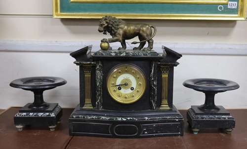 An early 20th century black slate clock garniture with metal...