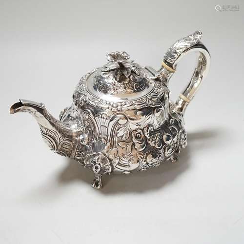 A William IV silver teapot, with floral knop, scroll and mas...