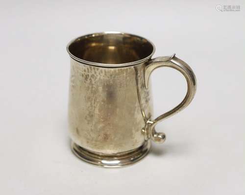 A George II silver half pint mug, engraved with a crest and ...