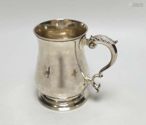 A George II silver baluster mug, with acanthus scroll handle...