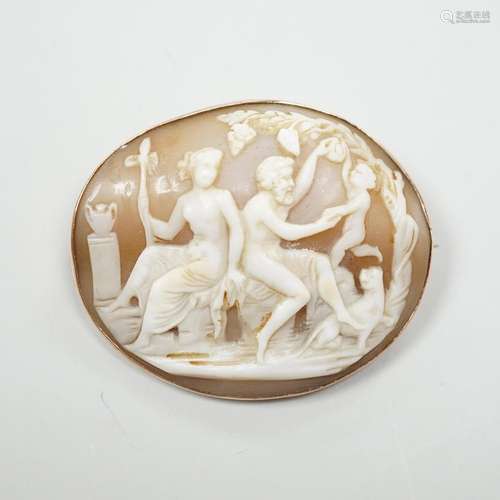 A gold mounted cameo brooch, carved with a classical family,...