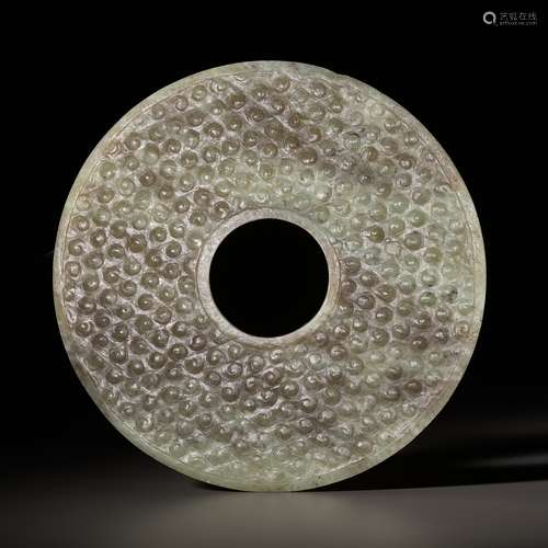 A CELADON AND BROWN JADE BI DISK, EASTERN ZHOU TO WARRING ST...