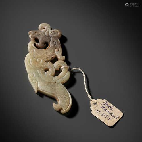 A SUPERB CELADON AND BROWN JADE ‘DRAGON’ PENDANT, WESTERN HA...