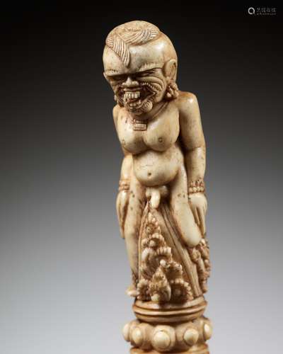 A CARVED BONE KRIS HILT IN THE FORM OF A MALE DEMON, INDONES...