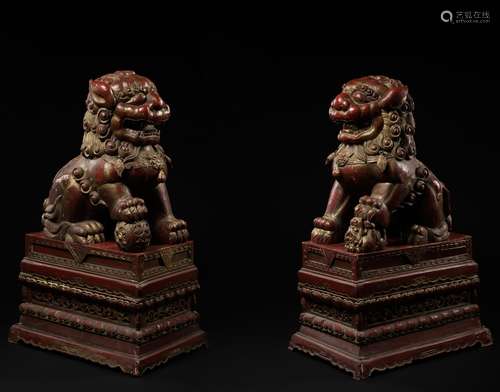 A PAIR OF MONUMENTAL GILT AND RED LACQUERED WOOD FIGURES OF ...