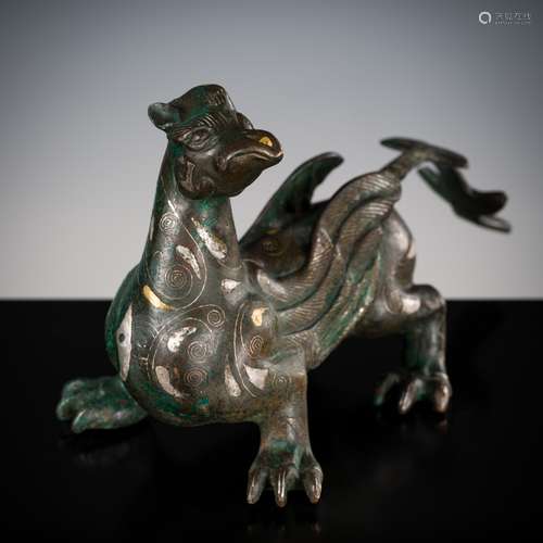 A SILVER- AND GOLD-INLAID ‘MYTHICAL BEAST’ BRONZE, CHINA, 17...