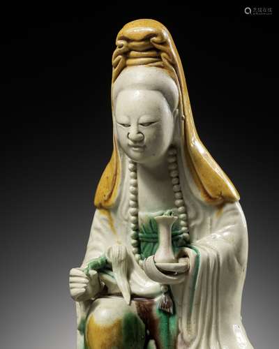 A BISCUIT-ENAMELED SANCAI FIGURE OF GUANYIN, KANGXI PERIOD