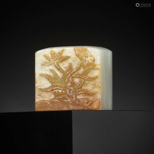 A WHITE AND RUSSET JADE ‘EGRET AND LOTUS’ ARCHER’S RING, QIN...