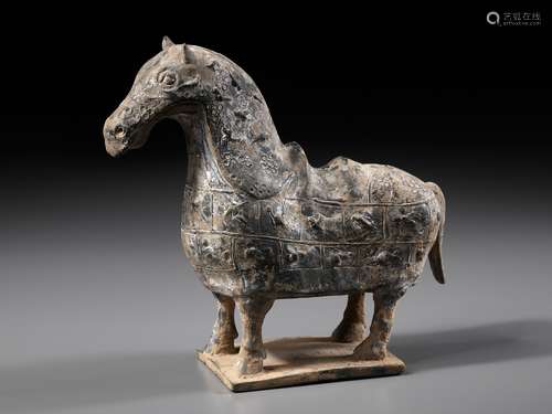 A RARE POTTERY FIGURE OF A FULLY ARMORED CHINESE CATAPHRACT,...