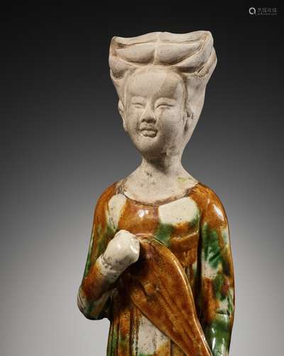 A SANCAI GLAZED POTTERY FIGURE OF A FEMALE MUSICIAN PLAYING ...