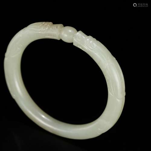 A PALE CELADON JADE ‘DRAGON’ BANGLE, CHINA, 19TH CENTURY