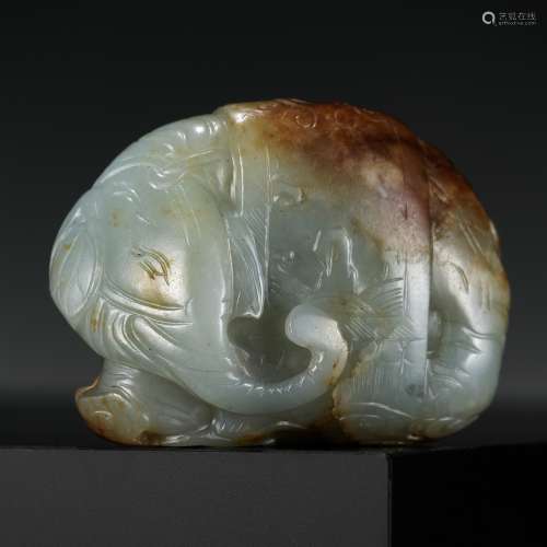 A CELADON AND RUSSET JADE CARVING OF AN ELEPHANT, LATE MING ...