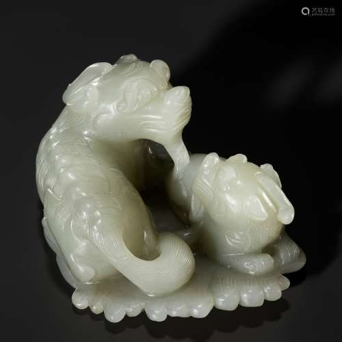 A PALE CELADON JADE ‘QILIN AND YOUNG’ GROUP, MID-QING DYNAST...
