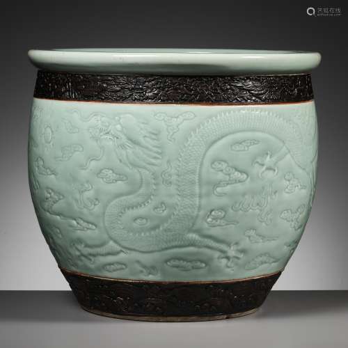 A LARGE MOLDED AND CARVED CELADON-GLAZED ‘DRAGON’ FISHBOWL, ...