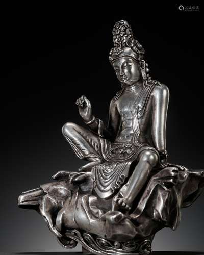 A SILVER FIGURE OF AVALOKITESHVARA IN ROYAL EASE, FIRST HALF...