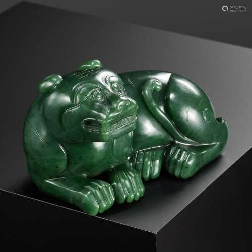 A RARE SPINACH-GREEN JADE FIGURE OF A TIGER, SECOND HALF OF ...