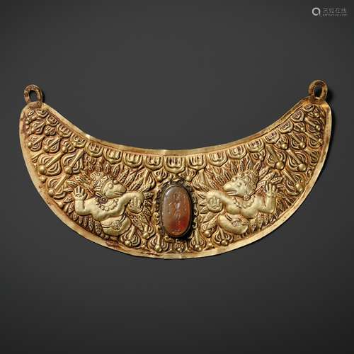 A GOLD REPOUSSÉ PECTORAL PENDANT DEPICTING TWO GARUDA, VIETN...