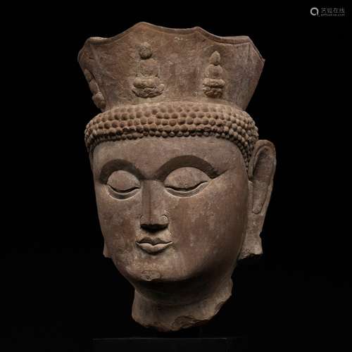 A MONUMENTAL HEAD OF VAIROCANA, THE PRIMORDIAL BUDDHA, CIRCA...