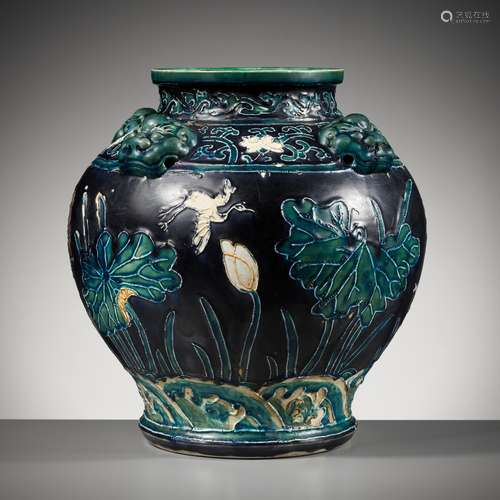 AN EARLY FAHUA-GLAZED ‘LOTUS’ JAR, GUAN, WITH FOUR LION-MASK...