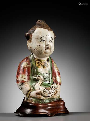 A CIZHOU POTTERY FIGURE OF A BOY WITH A DUCK, SONG TO YUAN D...