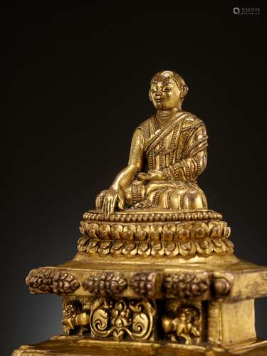 A GILT-BRONZE FIGURE OF A LAMA ON A STEPPED THRONE, TIBET, 1...