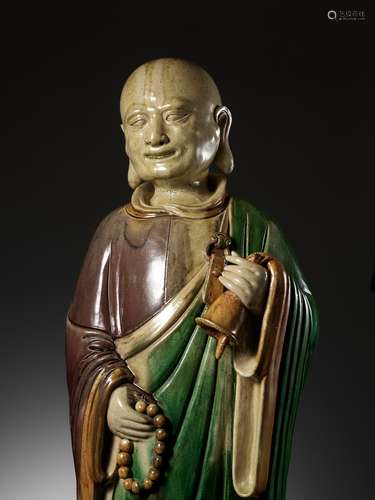 A MASSIVE SANCAI-GLAZED FIGURE OF A MONK, LATE MING DYNASTY ...