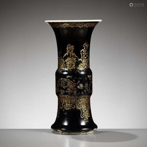 A MIRROR BLACK-GLAZED AND GILT-DECORATED ‘DRAGON’ VASE, GU, ...