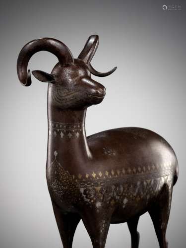 A QAJAR SILVER- AND GOLD-DAMASCENED IRON FIGURE OF AN IBEX, ...