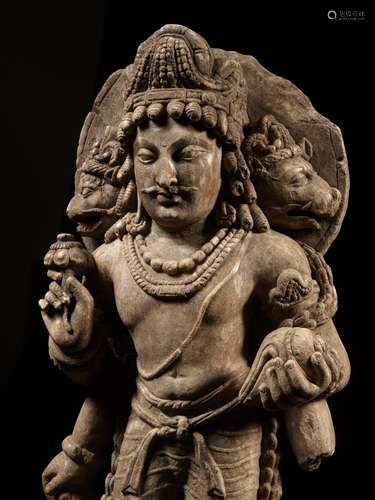 A LIMESTONE FIGURE OF THE THREE-HEADED VAIKUNTHA VISHNU, HIN...