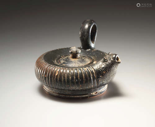 AN APULIAN BLACK-GLAZED GUTTUS WITH LION’S HEAD SPOUT  一件阿...