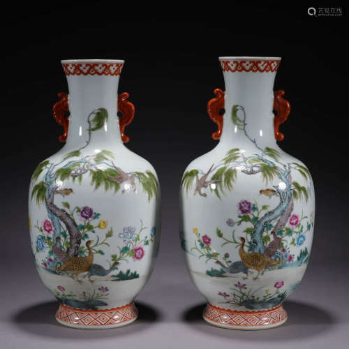 A PAIR OF FAMILLE ROSE FLOWER AND BIRD HANDLED VASES
