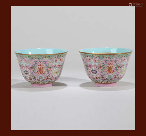 A PAIR OF CARMINE RED GROUND FLOWER CUPS