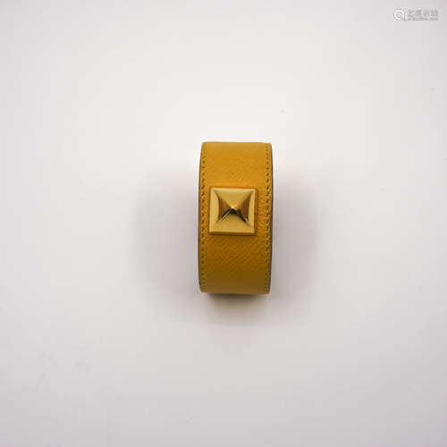 A HERMES YELLOW RIVET BRACELET