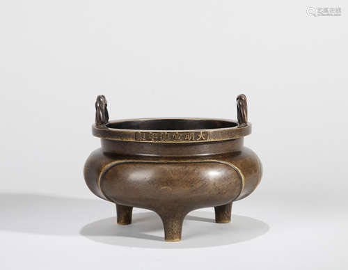 A BRONZE TRIPOD CENSER