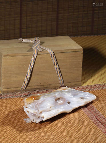 A CARVED AGATE SCROLL WEIGHT