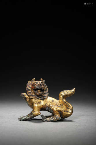 A GILT BRONZE LION ORNAMENT