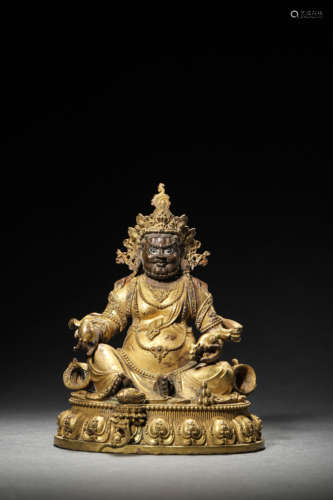 A GILT BRONZE FIGURE OF JAMBHALA