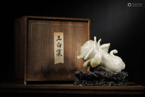 A WHITE JADE CARVING OF CHINESE CABBAGE WITH WOOD STAND