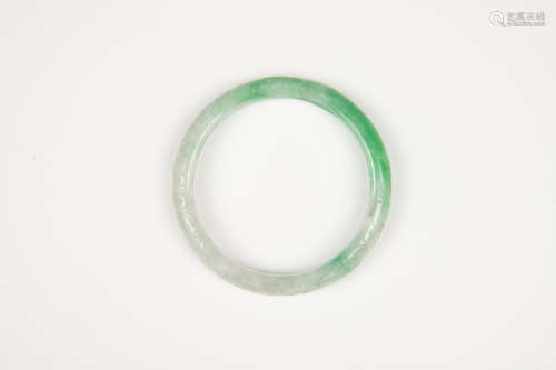 A Semi-Translucent Green Jadeite Carved ‘ Flowers’ Bangle