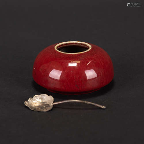 A COPPER RED GLAZED WATER POT WITH A SPOON
