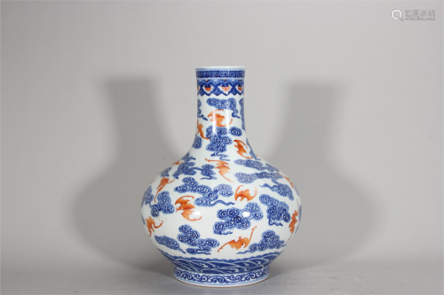 An iron red bat patterned blue and white porcelain vase,Qing...